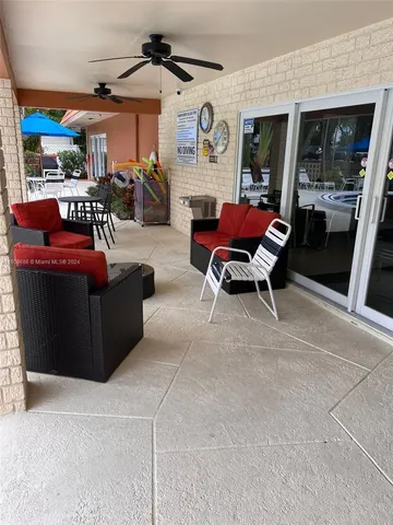 a living room with furniture a fireplace and a floor to ceiling window