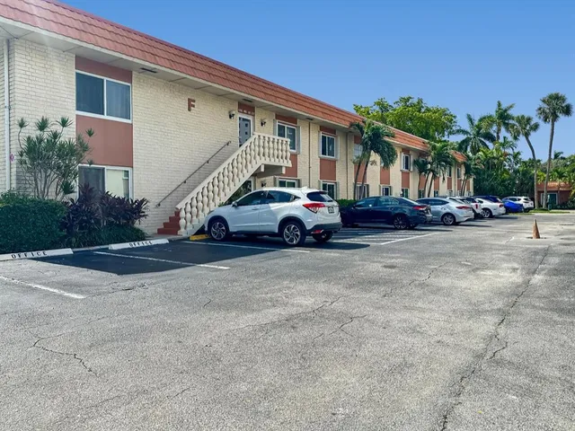 a car parked in front of white house