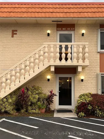 a front view of a house with plants