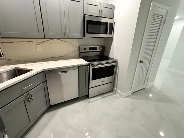a view of a kitchen with microwave and cabinets