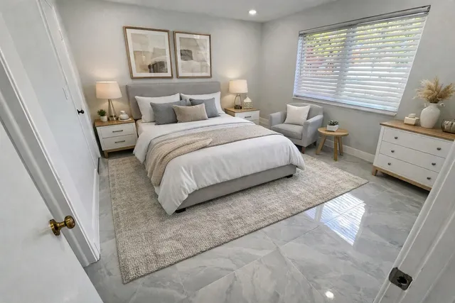 a bedroom with a bed and a large window