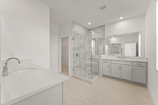 a bathroom with a shower sink and mirror