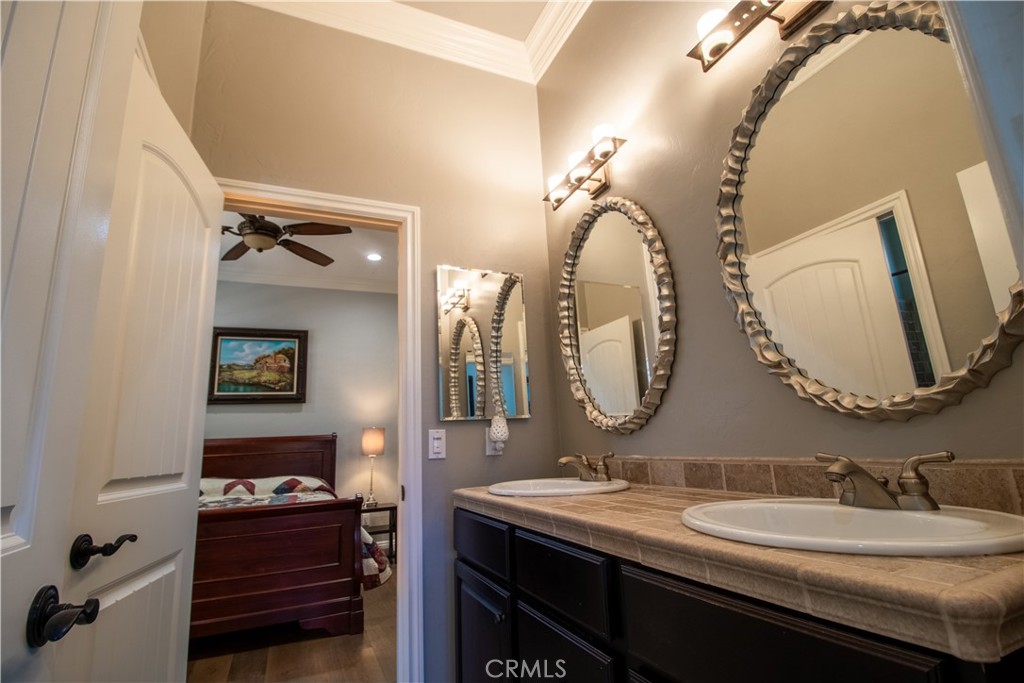 33699 Spring Brook Circle Temecula, CA 92592 - Photo 75 of 83 a en suite bathroom with a double vanity sink and a mirror