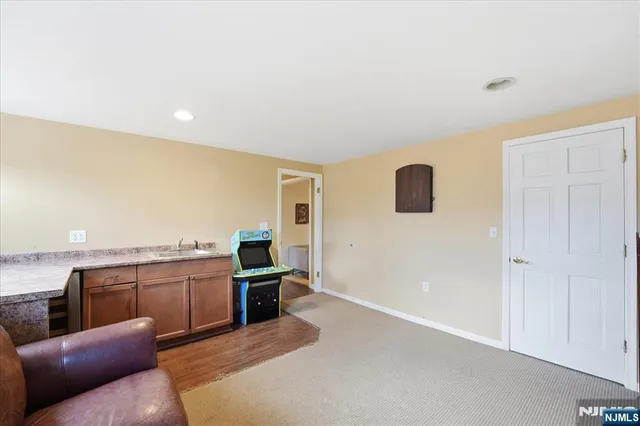 a living room with stainless steel appliances granite countertop lots of counter top space