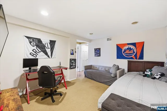 a living room with furniture a rug and white walls
