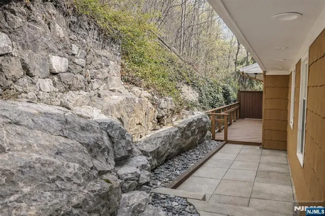 a view of an empty room with cabinet and a window