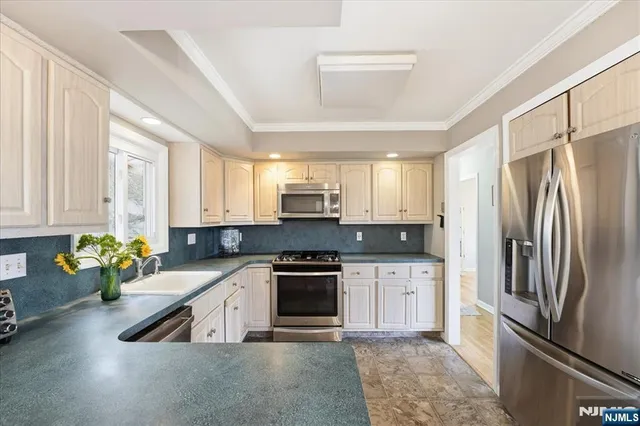 a kitchen with a sink refrigerator and window