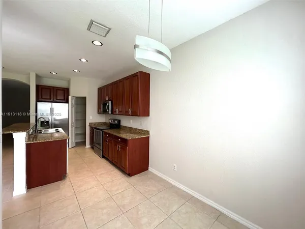 a kitchen with stainless steel appliances granite countertop a stove and a refrigerator