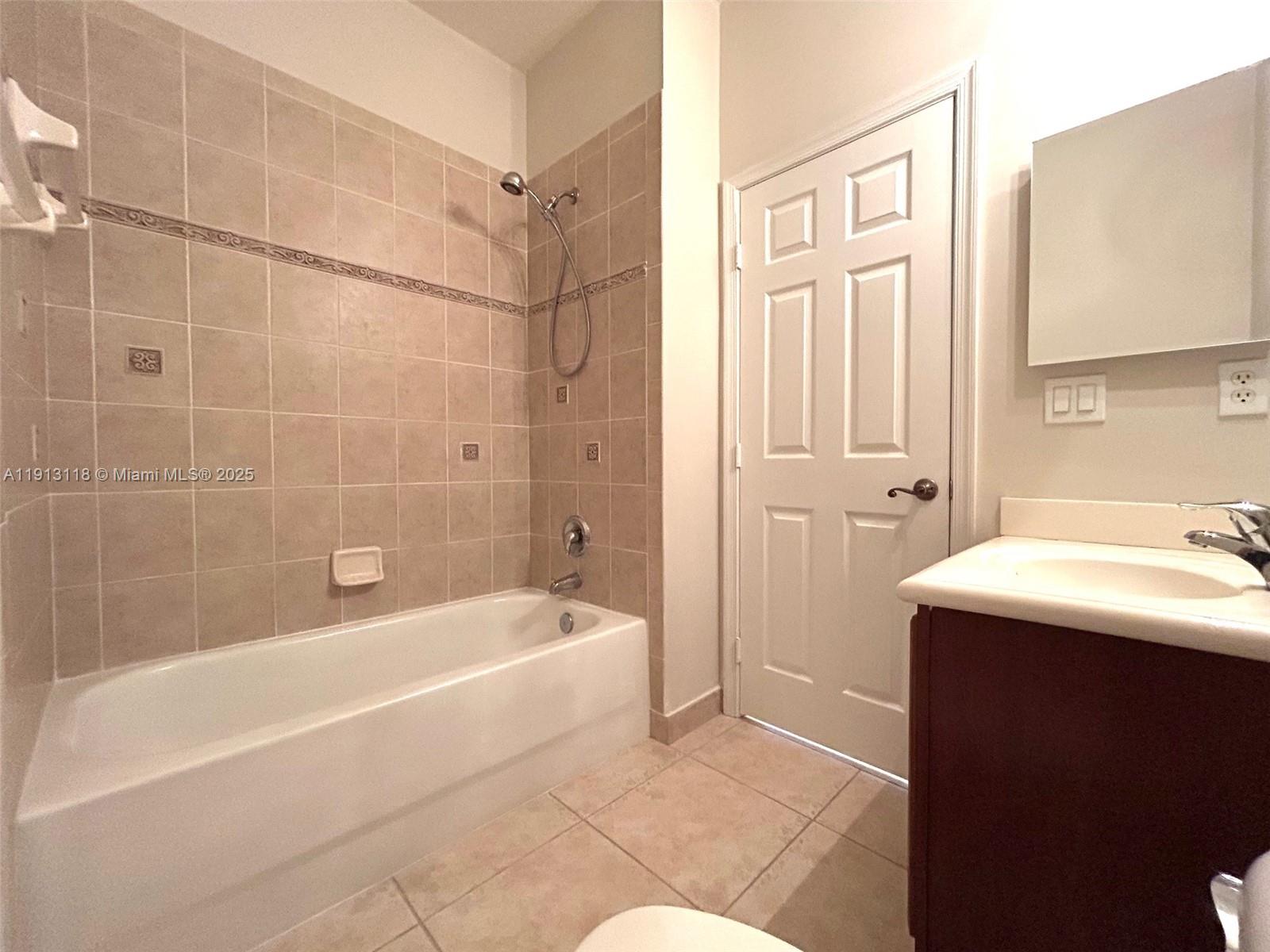 1560 Southeast Wilshire Place, Unit 103 Stuart, FL 34994 - Photo 21 of 33 a bathroom with a sink a bathtub and a shower