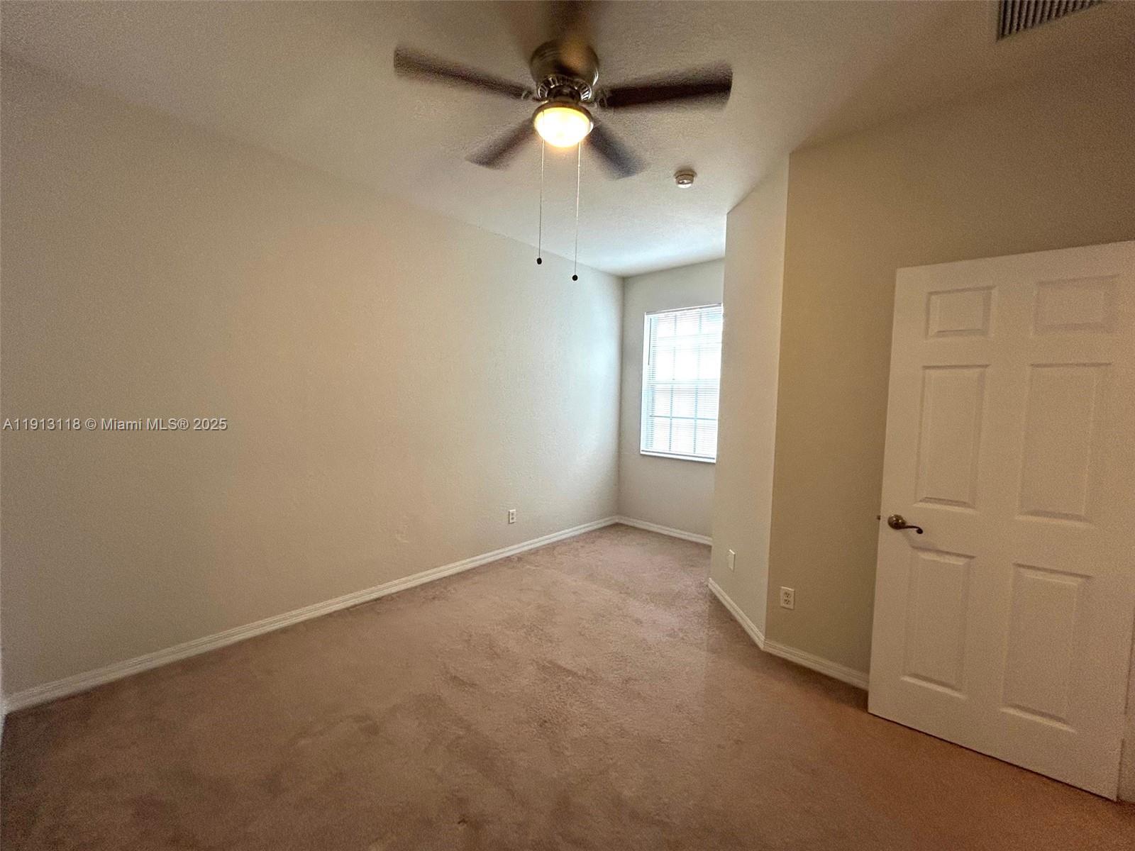 1560 Southeast Wilshire Place, Unit 103 Stuart, FL 34994 - Photo 27 of 33 wooden floor in an empty room with a window
