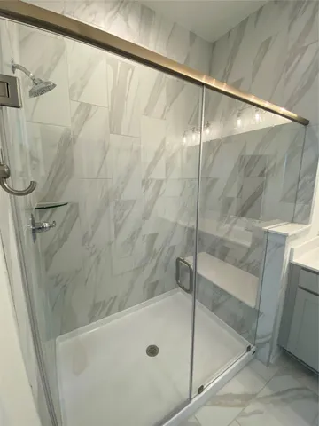 a bathroom with a shower and a sink