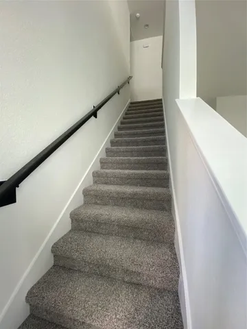 a view of a livingroom with a hall and wooden floor