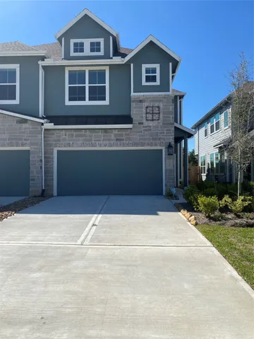 a front view of a house with yard and garage