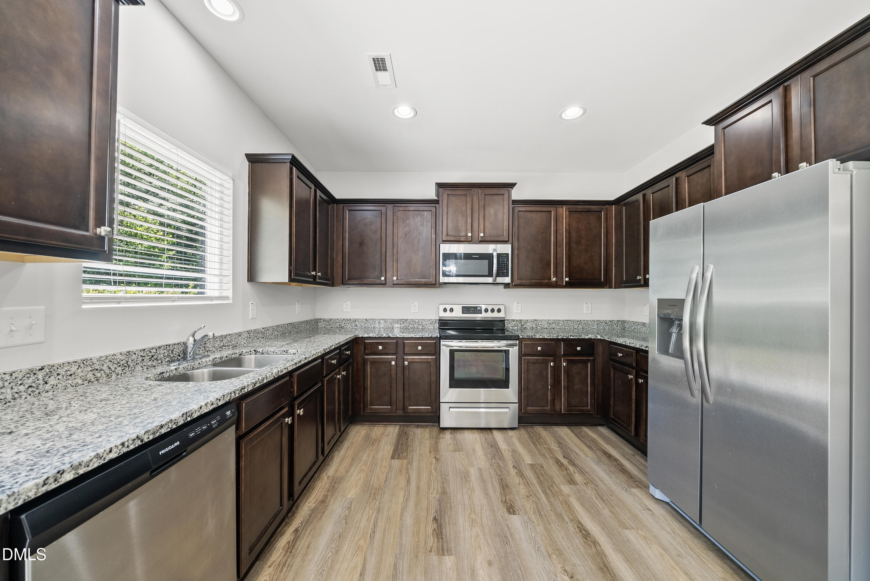 2816 Elsa Drive Raleigh, NC 27610 - Photo 16 of 35 a kitchen with stainless steel appliances granite countertop a refrigerator a sink dishwasher a stove top oven a refrigerator with island and chairs