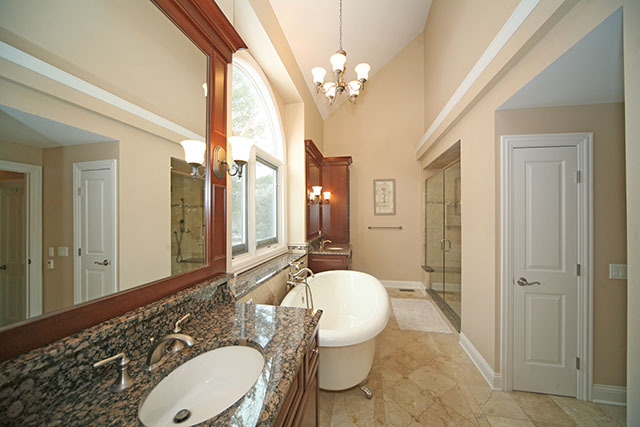 26W400 Churchill Road Winfield, IL 60190 - Photo 15 of 24 a spacious bathroom with a granite countertop sink toilet a mirror and shower