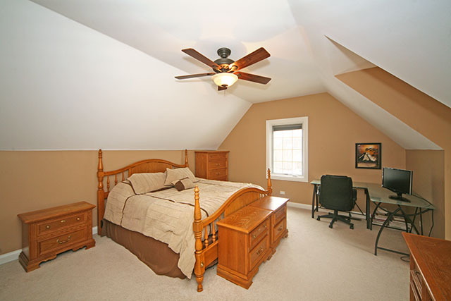 26W400 Churchill Road Winfield, IL 60190 - Photo 18 of 24 a bedroom with a bed and a chair