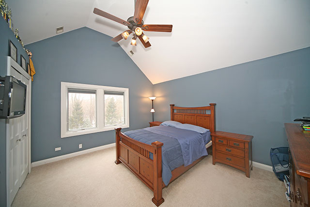 26W400 Churchill Road Winfield, IL 60190 - Photo 19 of 24 a spacious bedroom with a bed and a chandelier