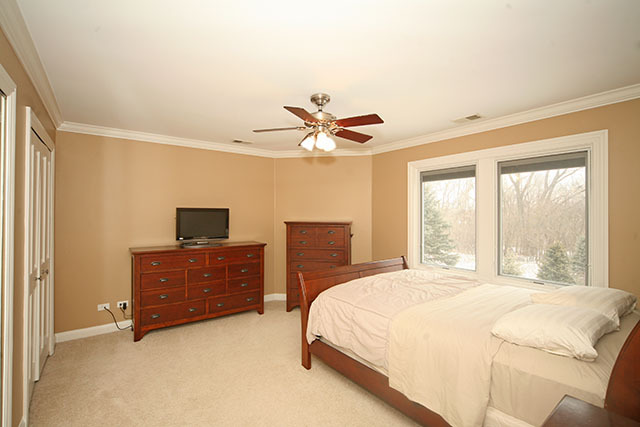 26W400 Churchill Road Winfield, IL 60190 - Photo 20 of 24 a bedroom with a bed and a dresser