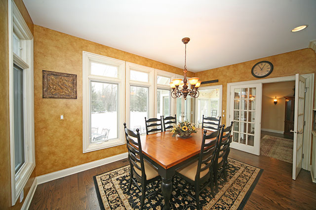 26W400 Churchill Road Winfield, IL 60190 - Photo 10 of 24 a dining room with furniture a chandelier and wooden floor
