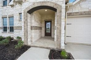 817 Paper Daisy Path Leander, TX 78641 - Photo 4 of 12 Elegant brick and stone facade welcomes with an inviting arched entryway.