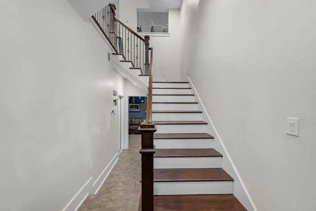 a view of entryway and gallery with wooden floor