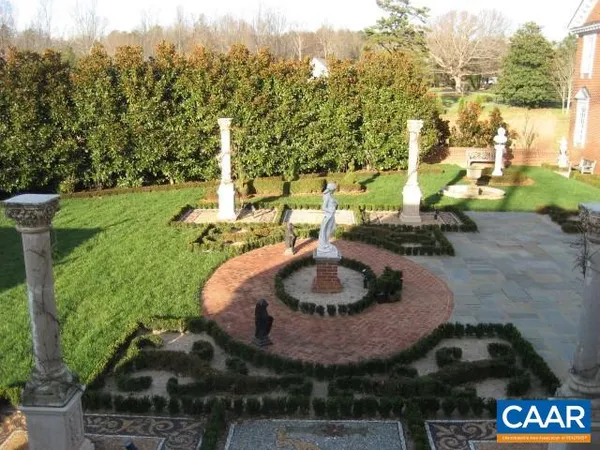 a backyard of a house with yard and outdoor seating