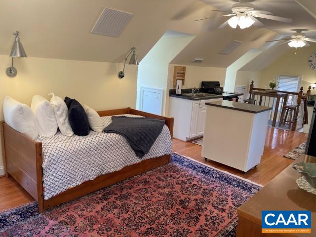 1920 Owensville Road, Unit B STUDIO Charlottesville, VA 22901 - Photo 16 of 26 a bedroom with a bed and wooden floor