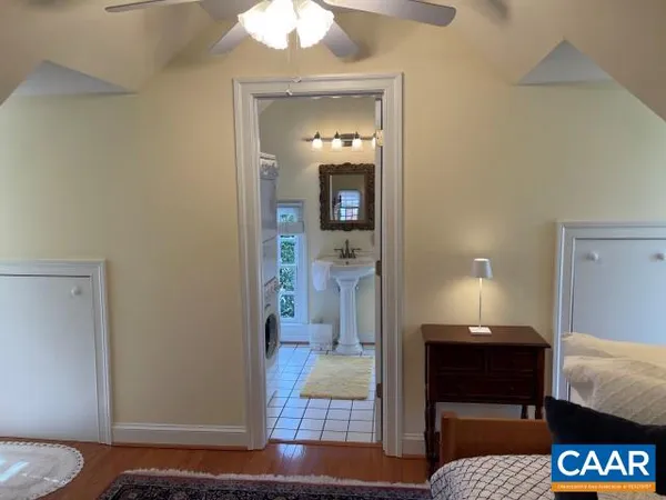 a bedroom with a bed and a mirror