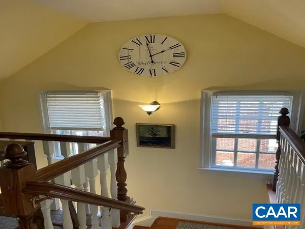 a view of entryway with a front door and wooden floor