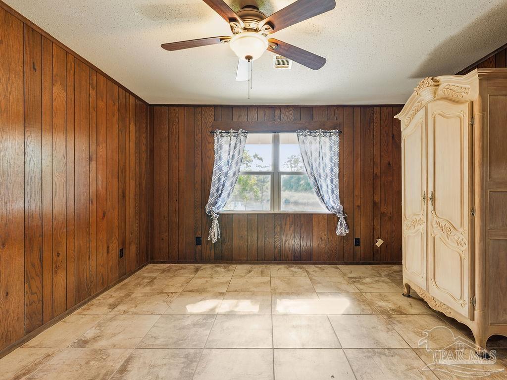 609 Dog Track Road Pensacola, FL 32506 - Photo 19 of 22 an empty room with windows and fan