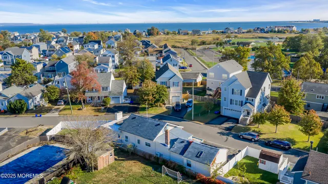 an aerial view of a house with a swimming pool outdoor seating and yard