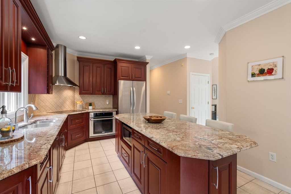 11 Black Elk Road Sharon, MA 02067 - Photo 8 of 28 a kitchen with stainless steel appliances granite countertop a sink stove and refrigerator