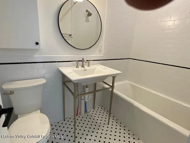a bathroom with a sink a toilet and a bathtub
