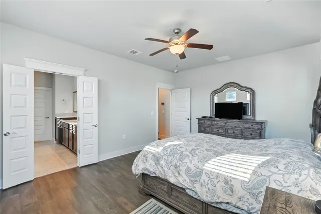 a bedroom with a bed and a wooden floor