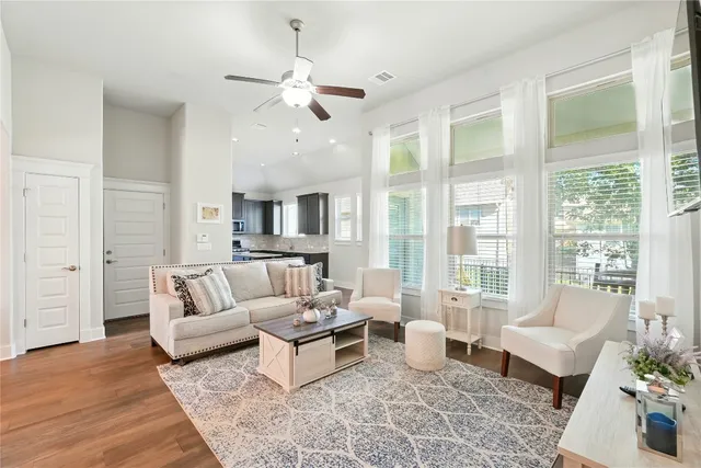 a living room with furniture and view of kitchen