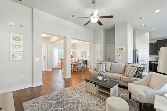a living room with furniture wooden floor and a chandelier