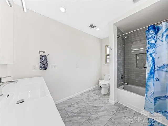 a bathroom with a shower and a toilet