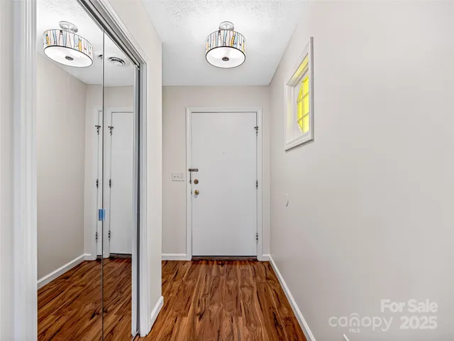 a view of a hallway with wooden floor