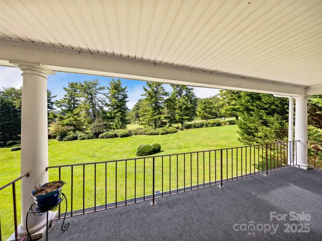 a view of balcony with floor to ceiling windows and wooden fence