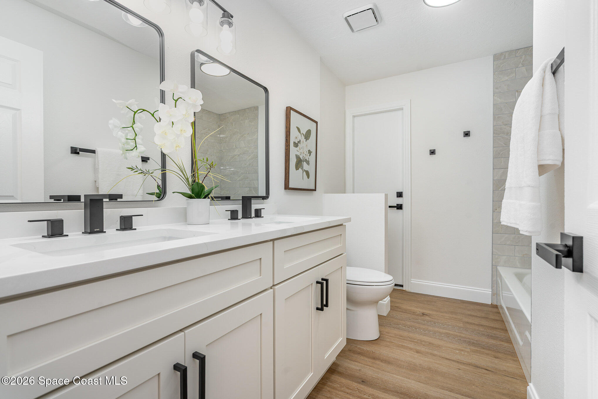 362 Nikomas Way Melbourne Beach, FL 32951 - Photo 19 of 32 a bathroom with a double vanity sink mirror and toilet