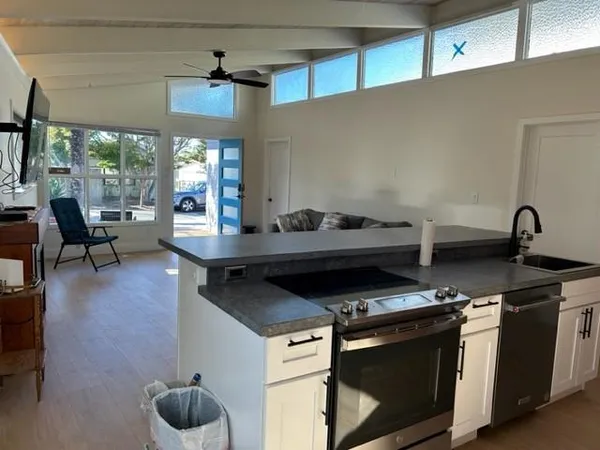 a kitchen with a stove and a wooden floors