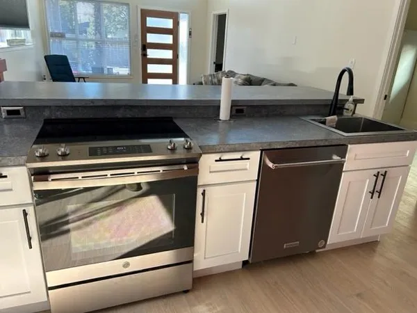 a stove top oven sitting inside of a kitchen