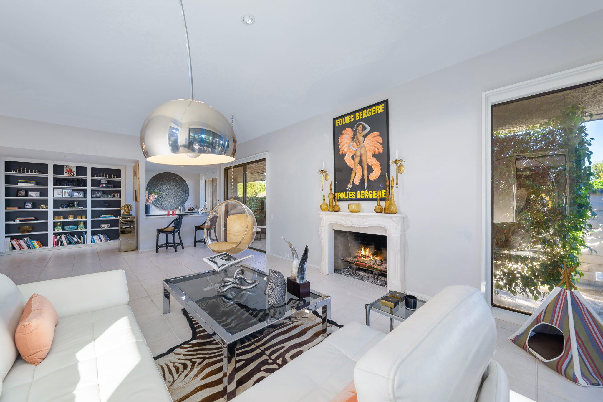 18 Lehigh Court Rancho Mirage, CA 92270 - Photo 15 of 53 a living room with furniture a fireplace and a chandelier