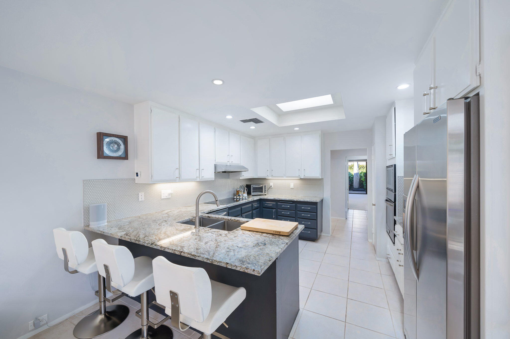 18 Lehigh Court Rancho Mirage, CA 92270 - Photo 18 of 53 a kitchen with stainless steel appliances granite countertop a refrigerator a stove a sink a dining table and chairs