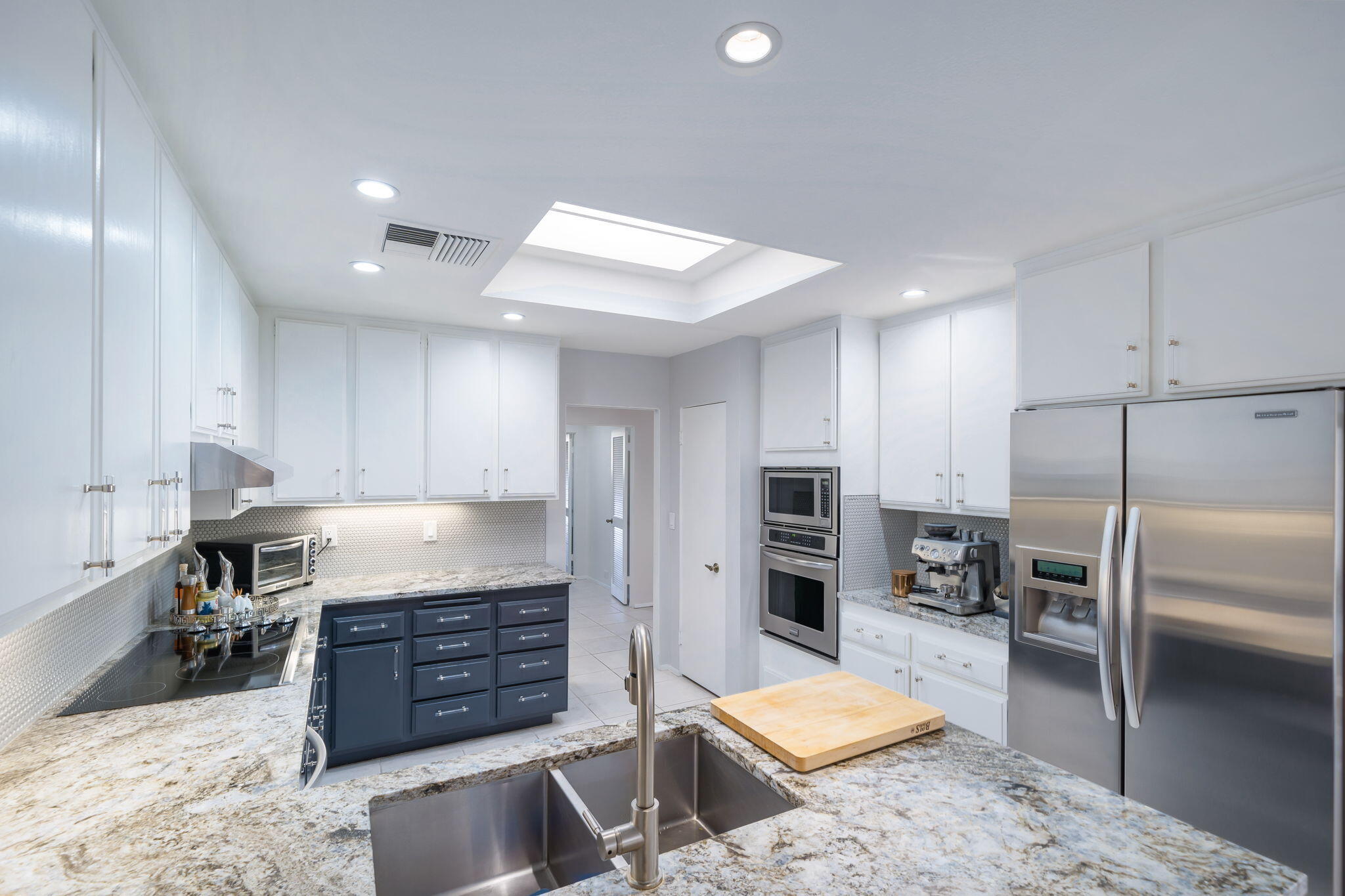 18 Lehigh Court Rancho Mirage, CA 92270 - Photo 20 of 53 a kitchen with stainless steel appliances kitchen island granite countertop a refrigerator and a sink