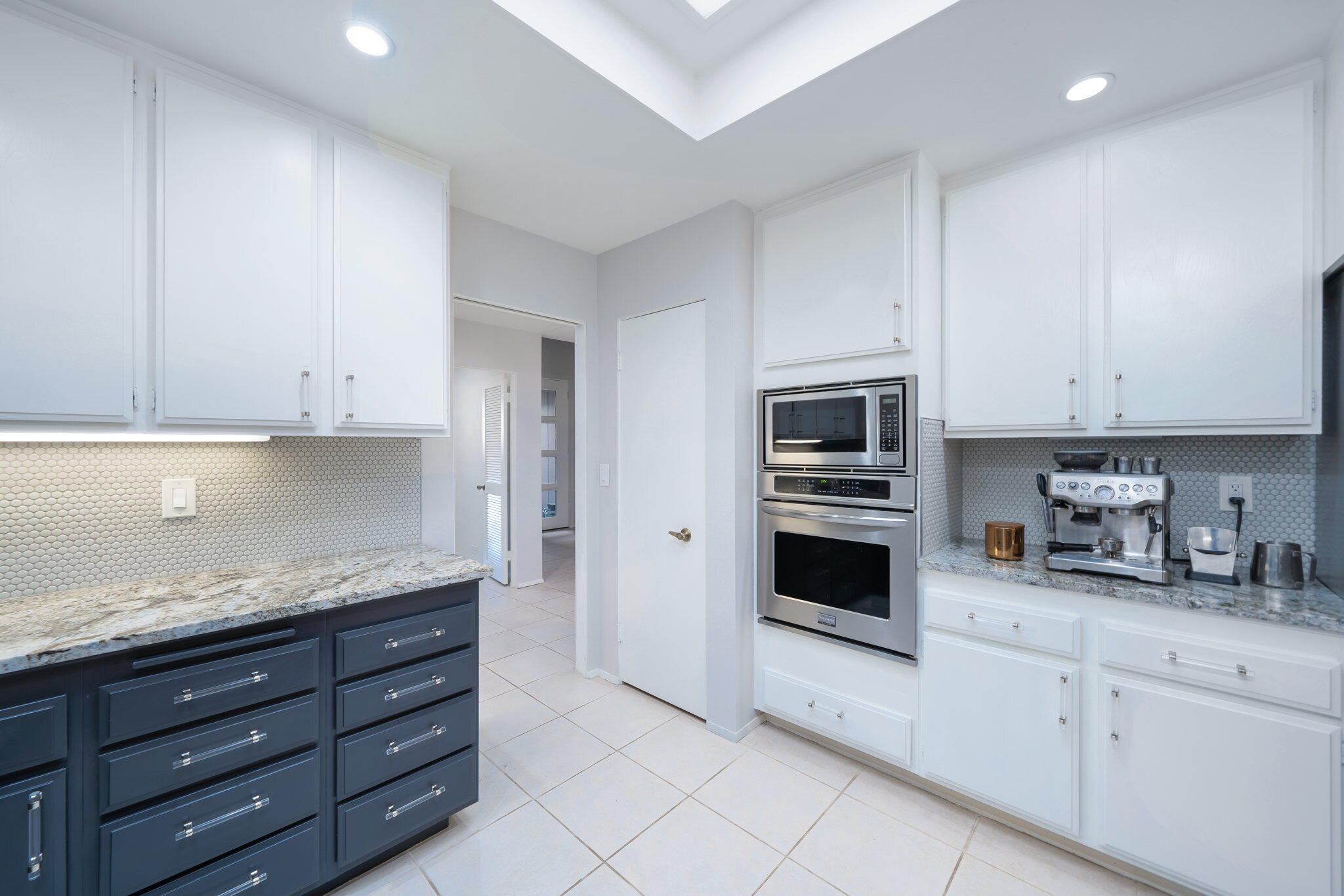 18 Lehigh Court Rancho Mirage, CA 92270 - Photo 22 of 53 a kitchen with granite countertop white cabinets and stainless steel appliances