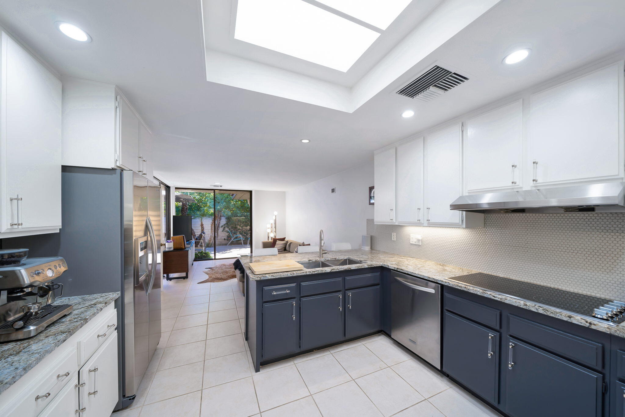 18 Lehigh Court Rancho Mirage, CA 92270 - Photo 24 of 53 a kitchen with stainless steel appliances granite countertop a sink counter space cabinets and a large window