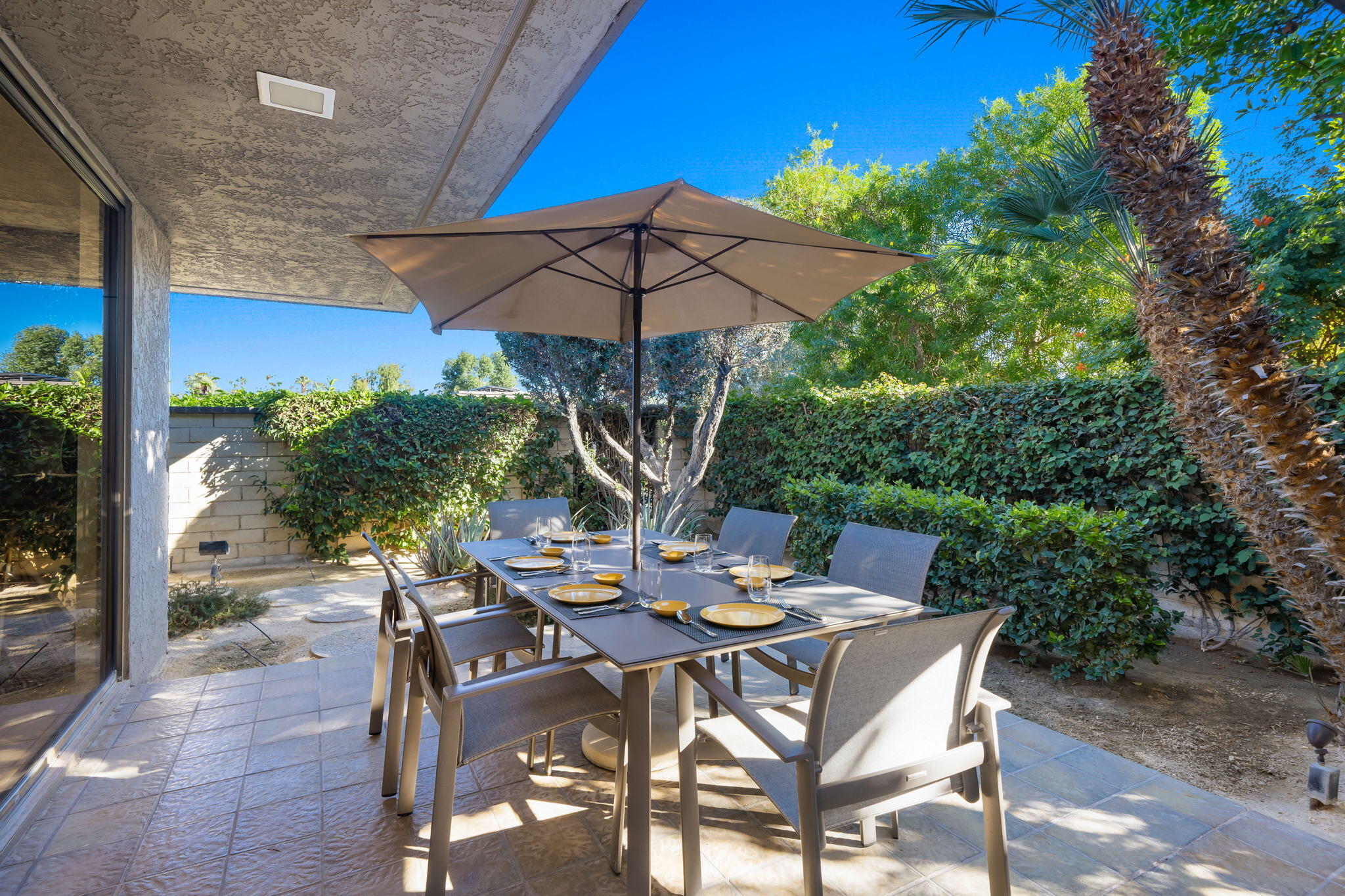 18 Lehigh Court Rancho Mirage, CA 92270 - Photo 40 of 53 a view of an outdoor space with table and chairs under an umbrella