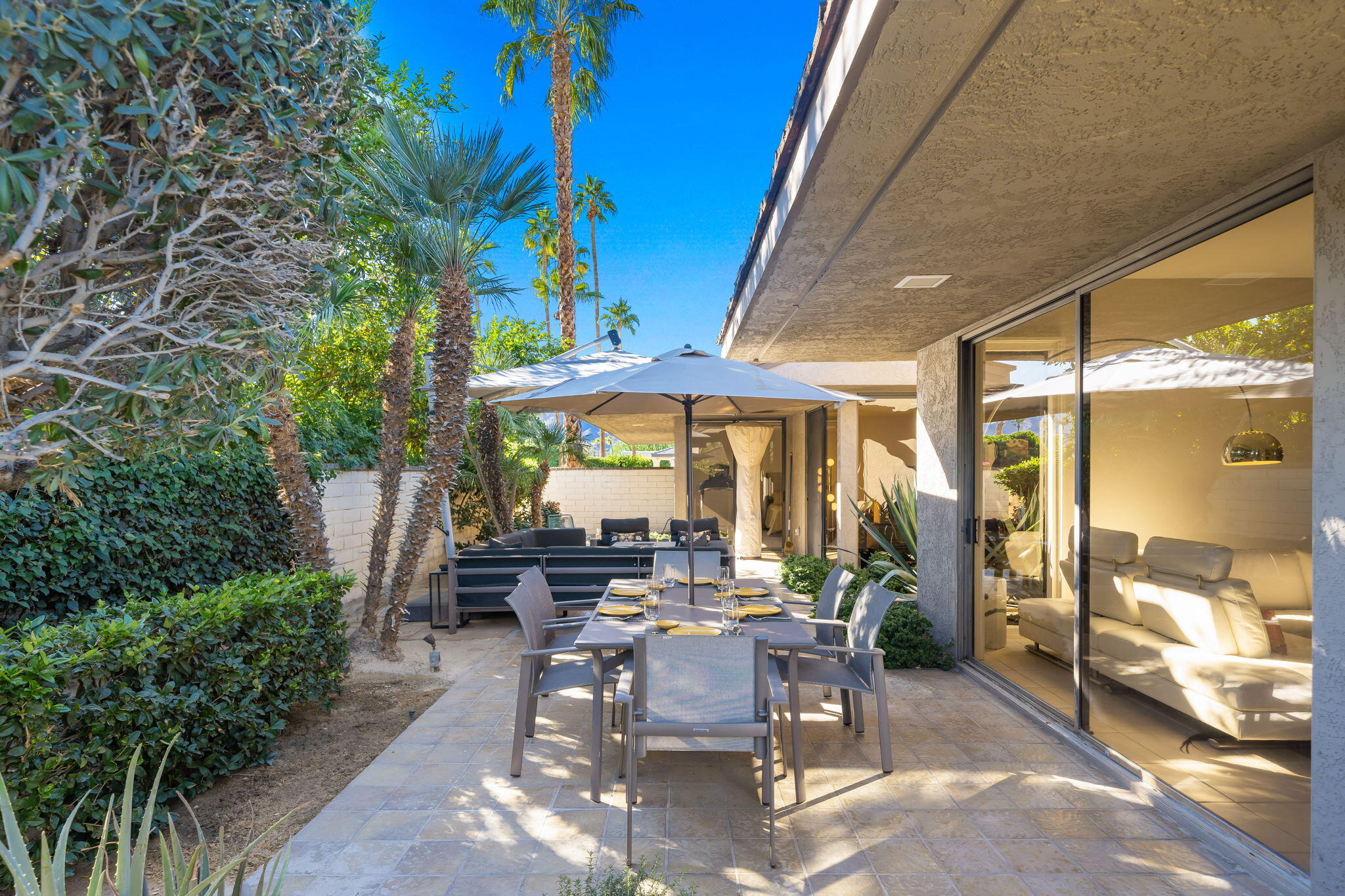 18 Lehigh Court Rancho Mirage, CA 92270 - Photo 41 of 53 a view of a patio with table and chairs under an umbrella