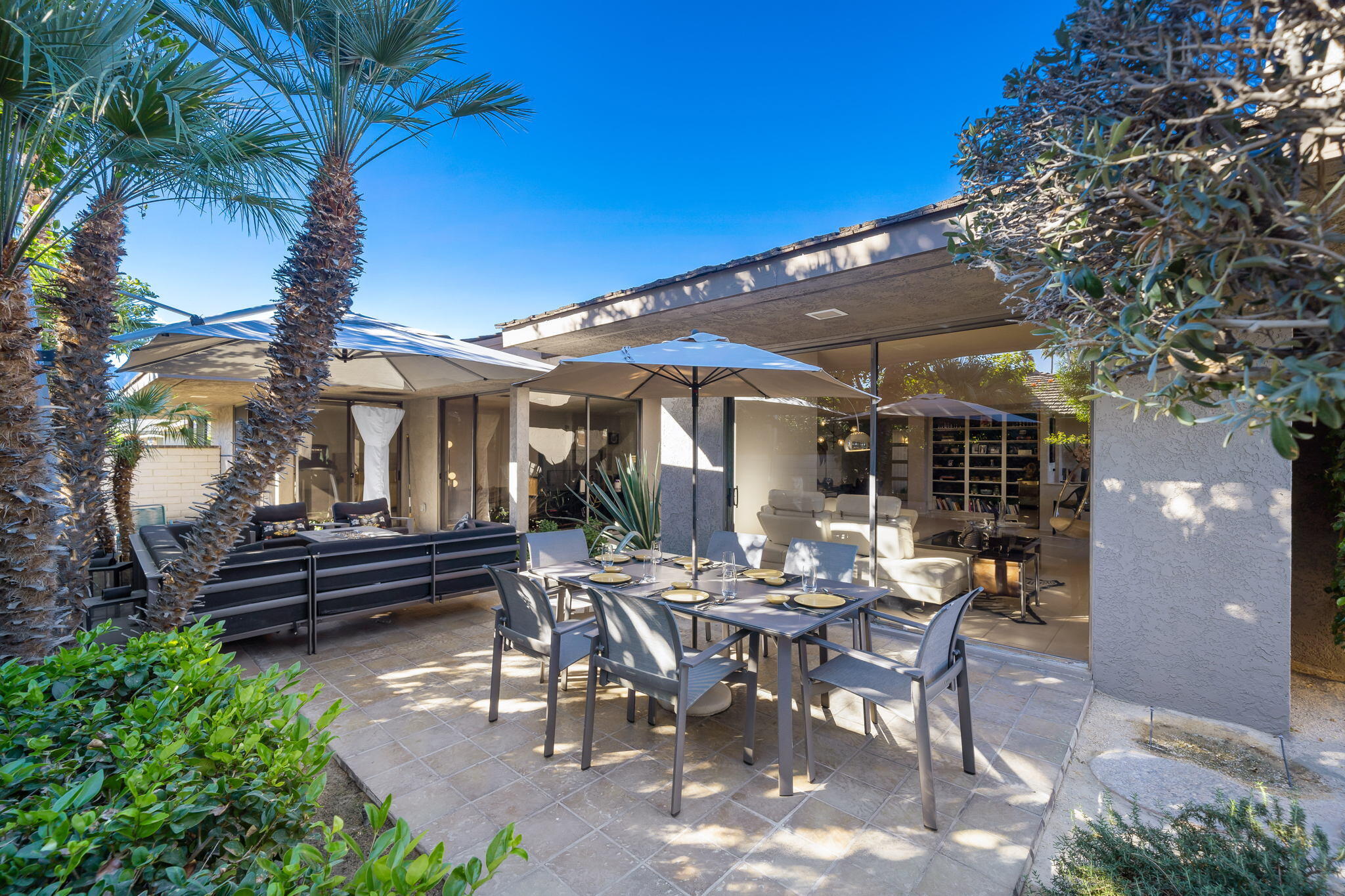 18 Lehigh Court Rancho Mirage, CA 92270 - Photo 42 of 53 a view of a patio with table and chairs and a large tree